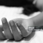 Picture of a numb hand of a woman showing death or unconsciousness