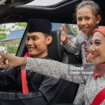 Malay family inside the car wearing traditional costume for Hari Raya festive