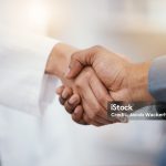 Doctor, patient and handshake in hospital thank you, welcome or greeting for medicine trust, help or medical consulting. Zoom, black man and shaking hands with pharmacy worker or healthcare employee