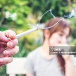 Passive smoking concept. Man is smoking cigarette and woman is covering her face ,Stop Smoking