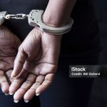 Black woman in handcuffs