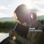 Young woman praying to god with the bible, Christianity, Concept of faith for god and teachings from the Bible.