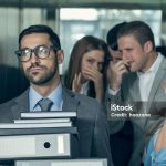 Smelly young businessman affecting his coworkers in an elevator